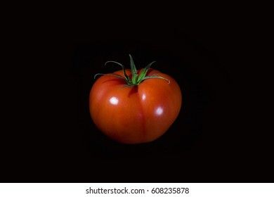 Red tomato on a black background
