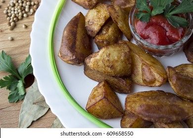 Country style fried potatoes with onions and ketchup. Fried potatoes in large slices.