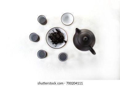 snuff cup with black tea, gaivan and a tea cup on a white backgroun