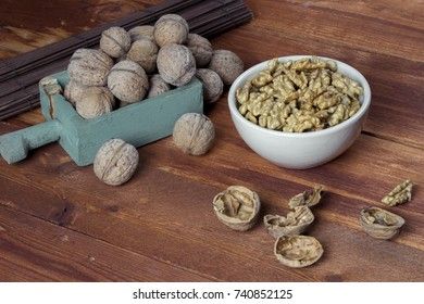 Peeled walnut in a white cup on a wooden background