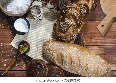 Bread composition with milk and flour on a wooden background